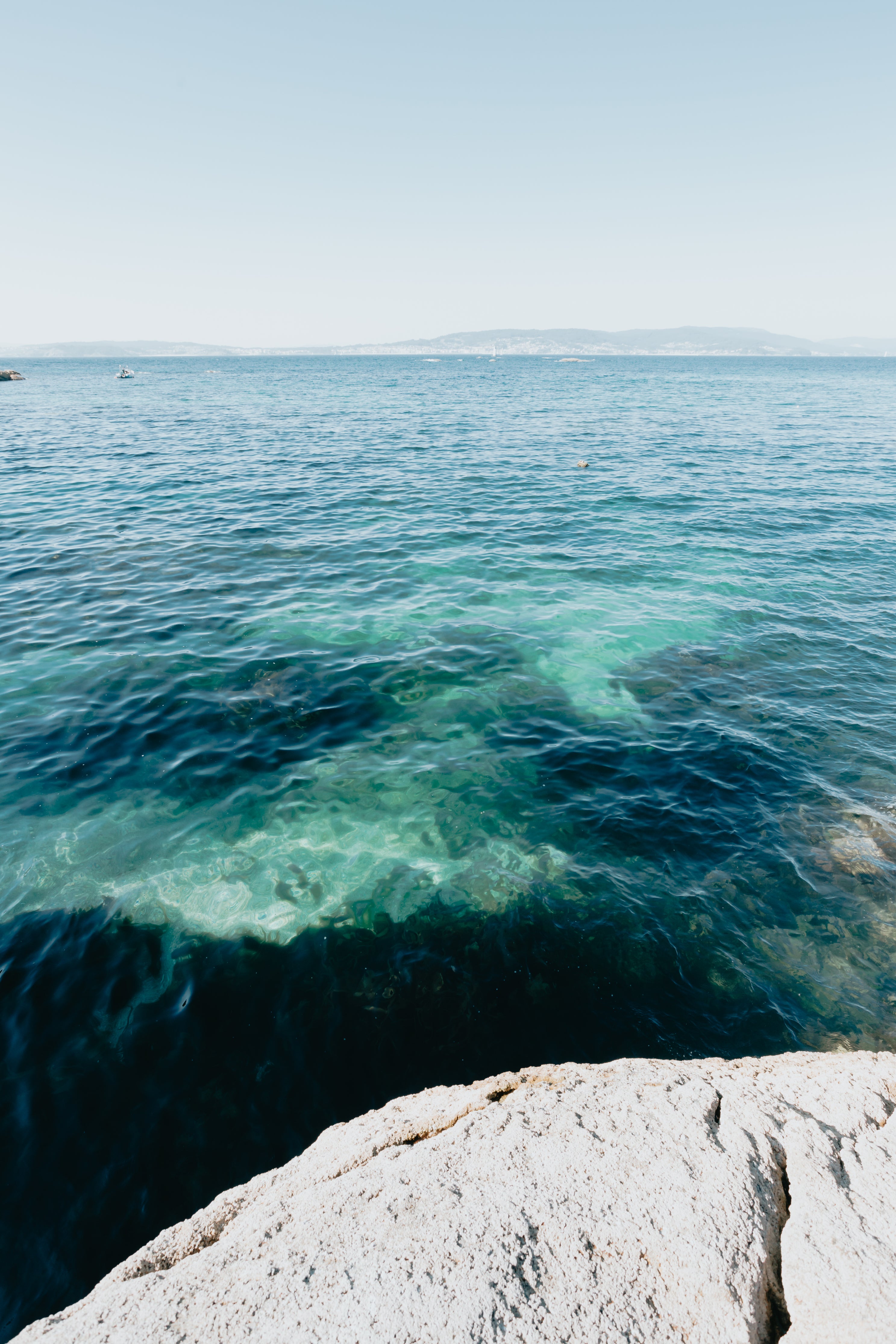 photo-of-blue-water-and-distant-land